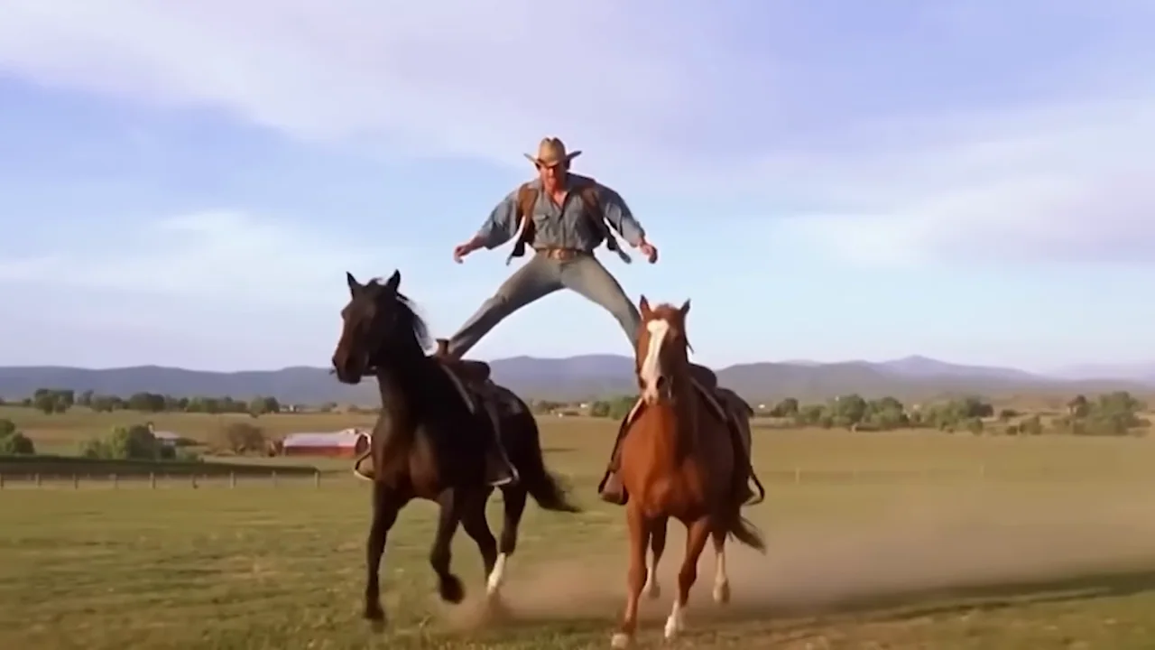 A rider spans two moving horses before the action resolves.